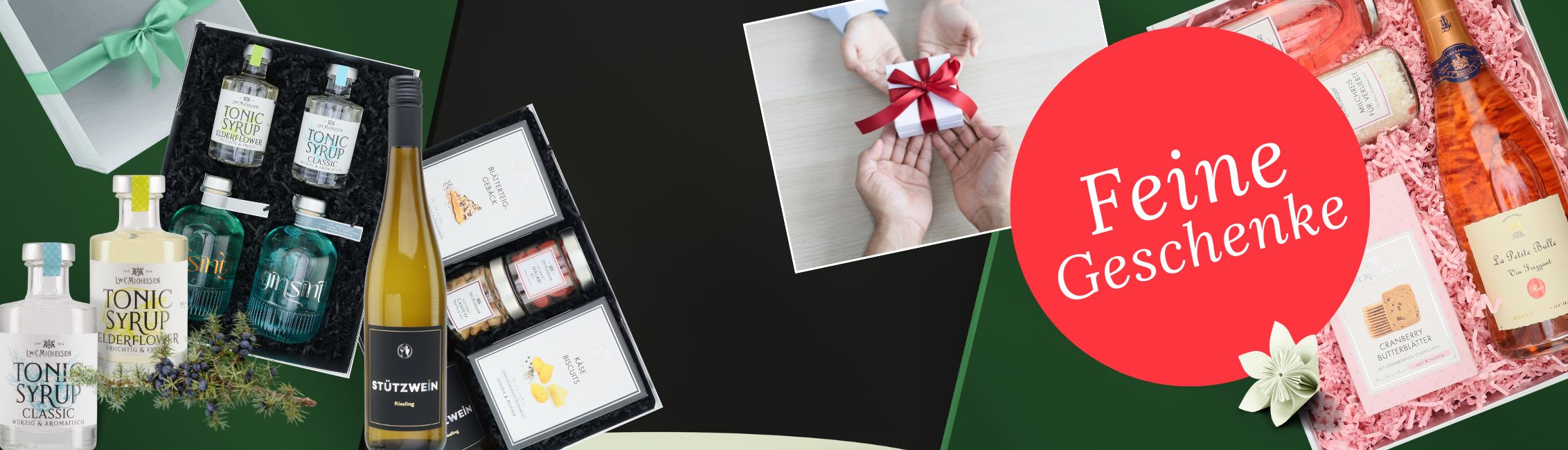 Verschiedene Geschenksets mit Tonic Sirup, Wein und Feinkost, verziert mit Blumen und Geschenken