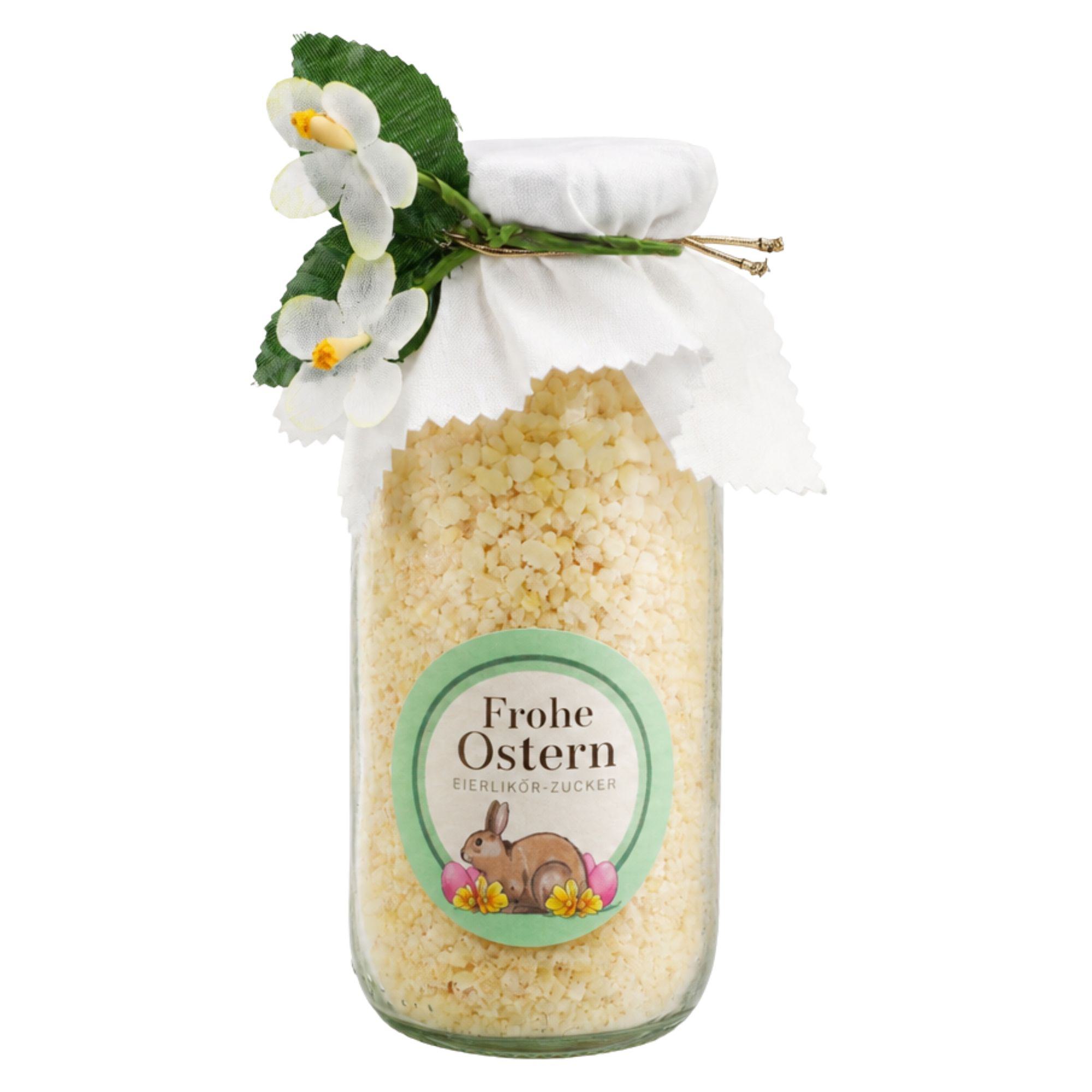 Eierlikör-Zucker „Frohe Ostern" im Glas mit weißer Stoffhaube und Blümchen-Dekoration